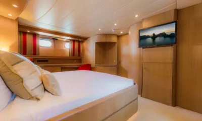 Aveline: Cabine com cama de casal, televisão fixada na parede, armários de madeira e vigias