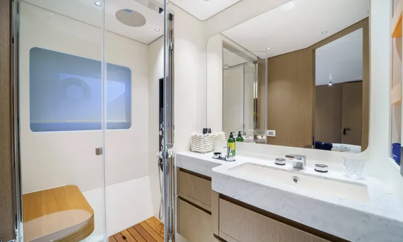 Getaway: Ensuite with marble basin, wide mirror and glass shower with a wooden seat