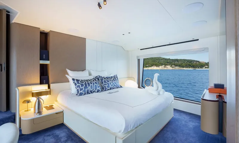 Getaway: Double cabin with blue patterned cushions, blue carpet and a large sea view window