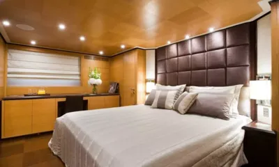 Ithaki: Cabina doppia con testiera imbottita, pannelli in legno, scrivania con fiori e tendina alla finestra