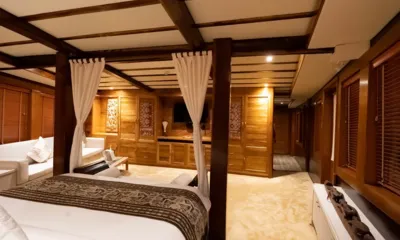 Lamima: Cabine espaçosa com cama de dossel, sofá branco e armários de madeira entalhada