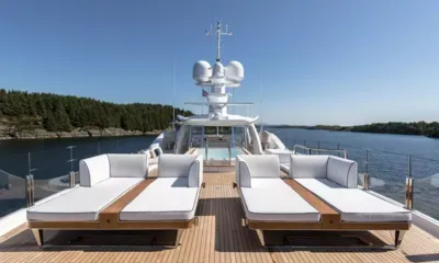 Lili: Top deck with white sun loungers on teak facing a jacuzzi and radar mast