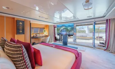 Maltese Falcon: Large cabin with pink bed, raised television and glass doors opening to a private deck