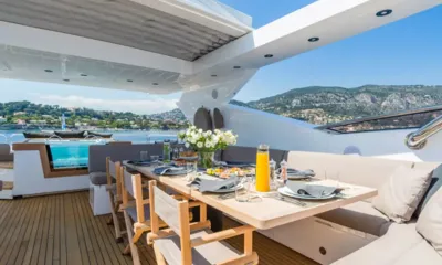 Maoro: Set outdoor dining table with flowers and juice on the upper deck, jacuzzi and hills behind