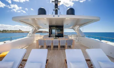 Moka: Top deck with sun loungers and an outdoor dining table under a hardtop