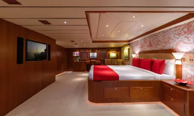 Northern Sun: Large cabin with a double bed in red and white linens, wall television and a sitting area