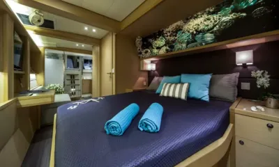 Ocean Views: Double cabin with navy bedspread, rolled blue towels and sea themed artwork