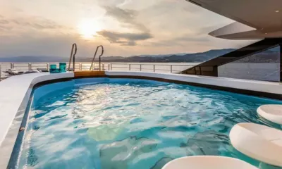 Suerte: Deck jacuzzi with in water seats, sun loungers and hills at sunset