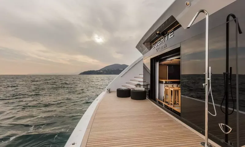 Suerte: Teak stern deck with outdoor shower, stools and an open bar area by the sea