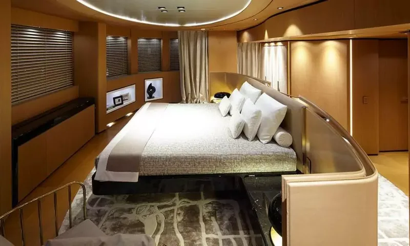 Suerte: Large bed with white pillows in a wood panelled cabin with blinds