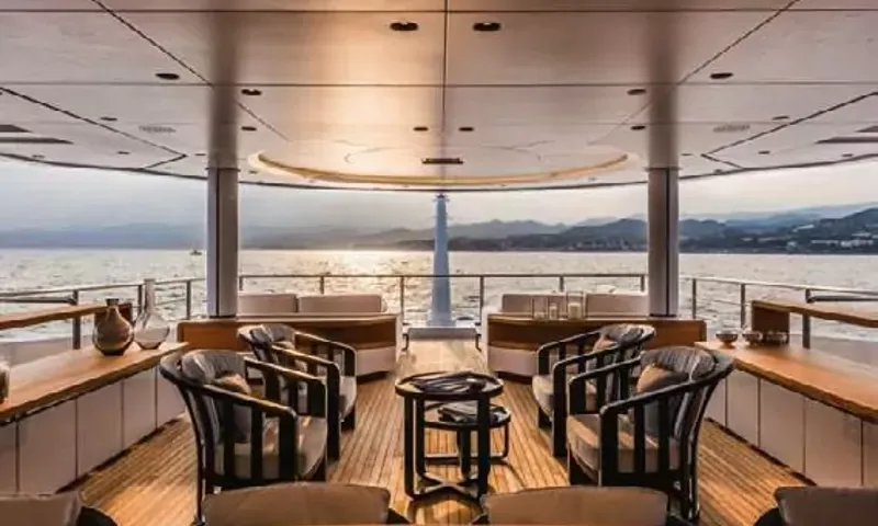 Suerte: Covered deck with armchairs around a small table looking out to sea and mountains