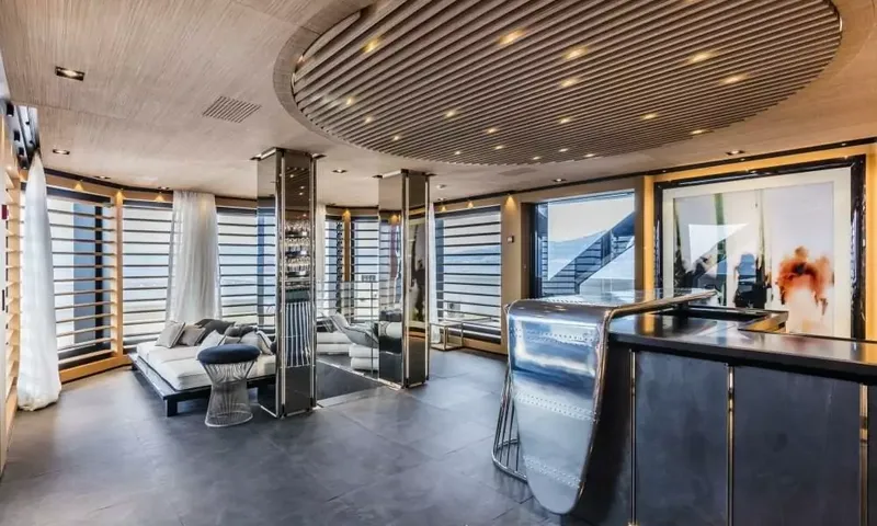 Suerte: Lounge with metal clad bar, slatted windows, daybed and grey stone floor
