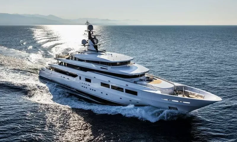 Suerte: White superyacht cruising across sunlit sea seen from above, foredeck and upper decks visible