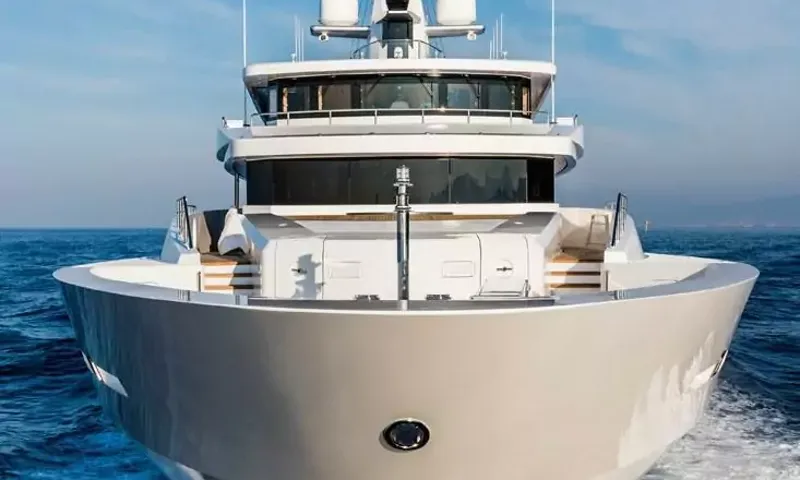 Suerte: Head on view of the yacht bow and superstructure under way on blue sea