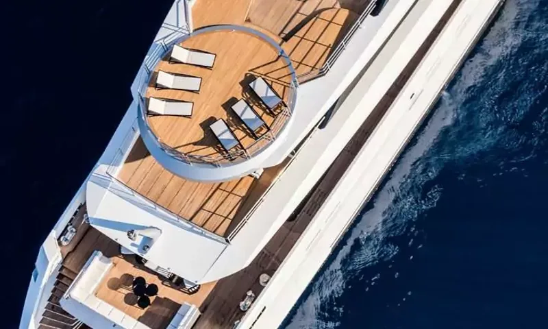 Suerte: Overhead view of a round teak top deck with sun loungers and decks below