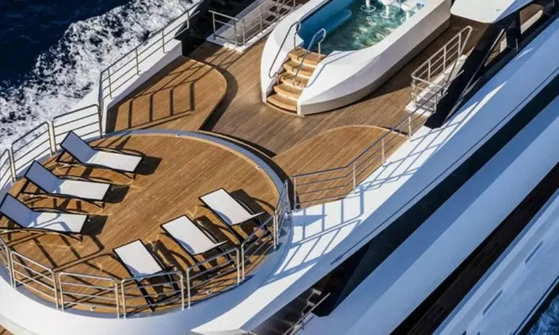 Suerte: Top deck with sun loungers on a round teak area and a pool with steps