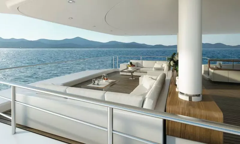 Suerte: Shaded deck lounge with white sofas and low tables facing the sea and mountains