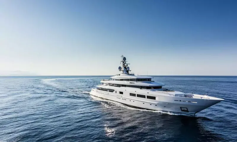 Suerte: White superyacht cruising on calm blue sea under a clear sky