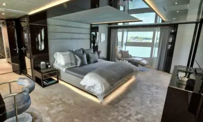 Take 5: Large cabin with grey bed, padded headboard, lounge chair and tall windows