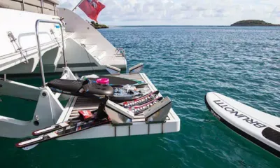 Vacoa: Plataforma de popa bajada con esquís acuáticos, una tabla de wakeboard y un flotador remolcable junto a una tabla de paddle surf