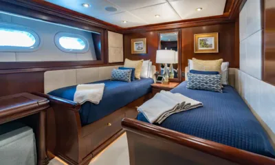 Zoom Zoom Zoom: Twin cabin with two single beds in navy covers, wood paneling and portholes