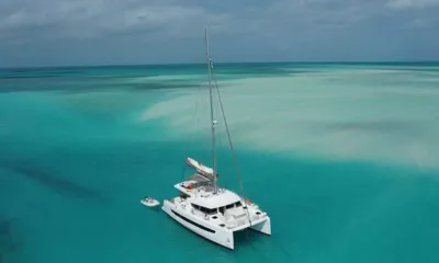 Interlude: Catamaran anchored over turquoise sandbanks with its tender alongside