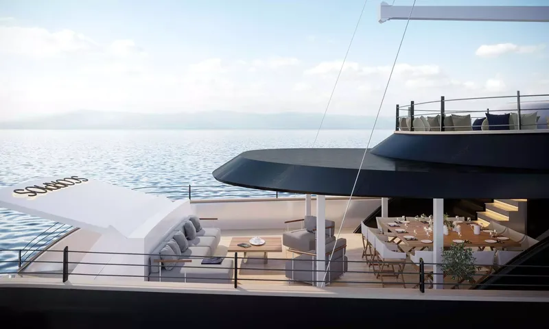 Scorpios: Side view of aft deck with sofa lounge and laid dining table under an overhang