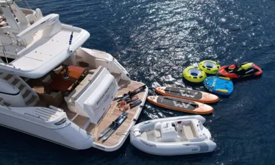 Distar Princess: Stern of the yacht from above with paddleboards, tubes, a jet ski, tender and water skis