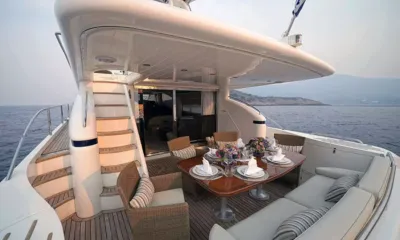 Distar Princess: Aft deck table set for dinner with wicker chairs, flowers and sea view