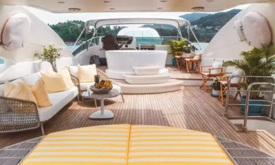 For Your Eyes Only: Ponte superiore con divano lounge, jacuzzi rialzato, sedie pieghevoli e timone sotto un hardtop