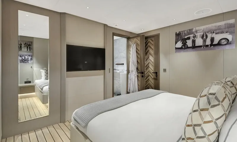 All About U 2: Cabin with bed, wall television, tall mirror and a robe on the ensuite door