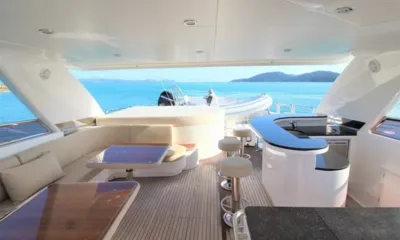 Euphoria: Deck superior sombreado com assentos lounge, bar com banquetas e um bote auxiliar guardado na popa