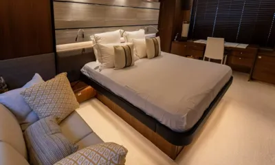 S72: Cabin with double bed, cushioned sofa and a desk beneath shaded windows