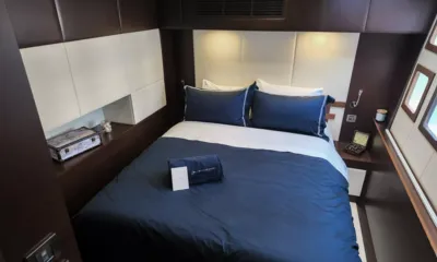 Feng: Double cabin with navy bedding, padded headboard and small side windows