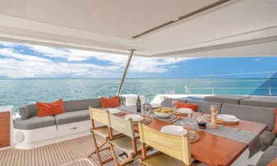Okinawa: Aft deck dining table laid for a meal with sea and sky beyond