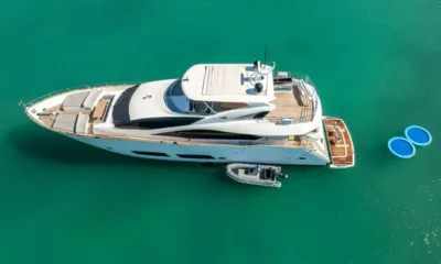 Rmm Job: Vista aérea del yate fondeado con un auxiliar al costado y dos colchonetas flotantes a popa