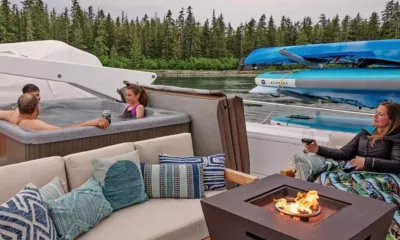 Dauntless: Hóspedes em uma hidromassagem e ao lado de uma mesa de fogo no deck superior com pranchas de stand up paddle guardadas