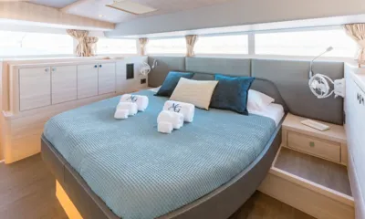 Mary's Grace: Cabine com cama grande, colcha azul, toalhas enroladas e janelas amplas