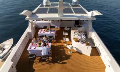 Vision: Guests eating at deck tables beside a buffet, seen from above