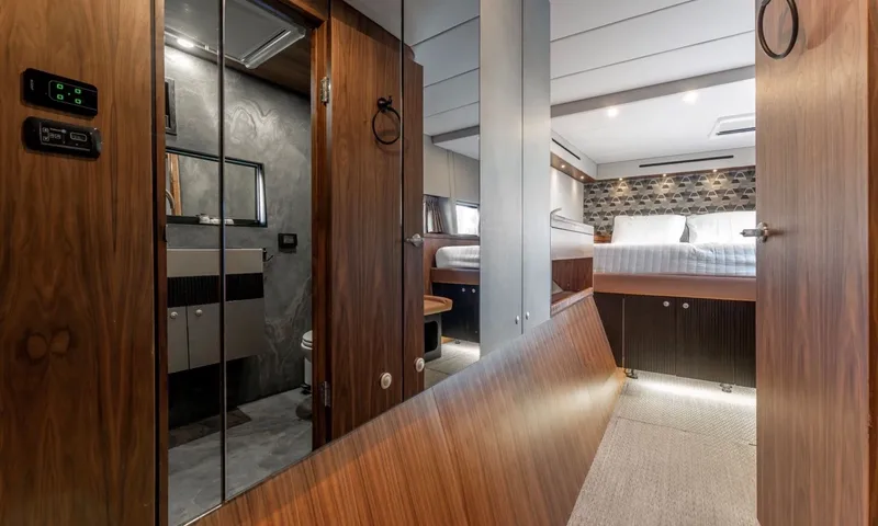 Hani I: Wooden corridor leading to a cabin with bed, ensuite visible through open door
