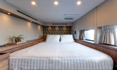 Hani I: Double bed cabin with patterned headboard wall, wood ledges and curtained windows