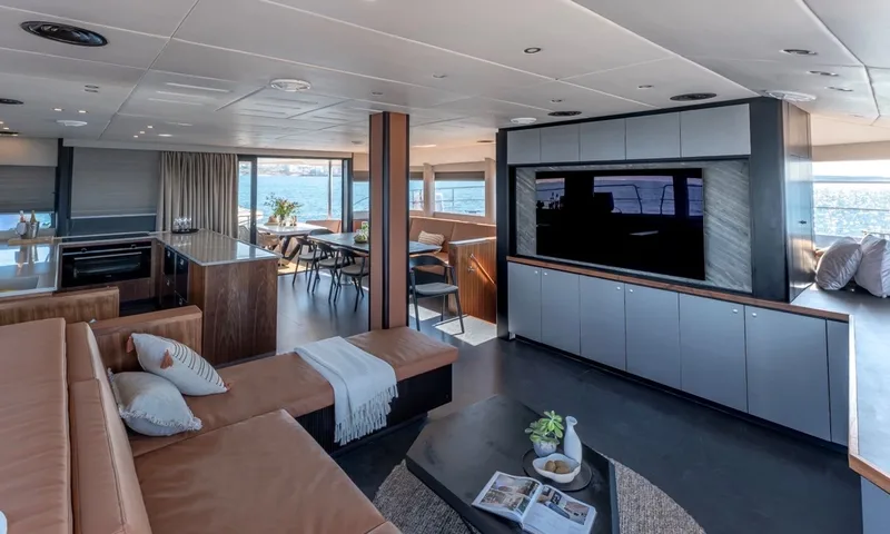 Hani I: Open plan saloon with leather sofa, television cabinet, kitchen and dining area