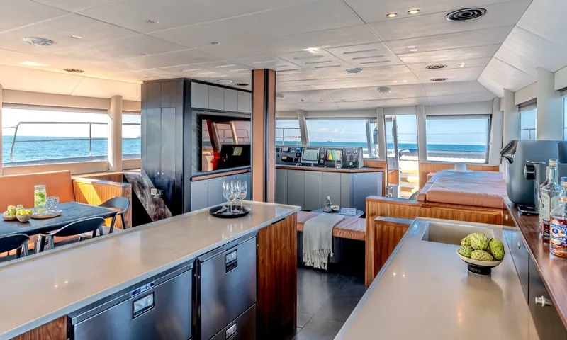 Hani I: Open galley counters with fridge drawers, overlooking dining area and helm