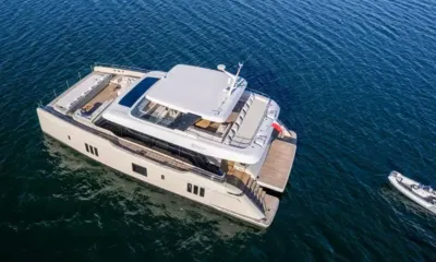 Bohemia: Aerial view of catamaran showing decks and lowered stern platform with tender alongside
