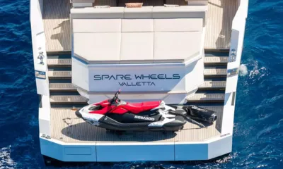 Spare Wheels: Jet ski resting on the stern swim platform below a sunpad