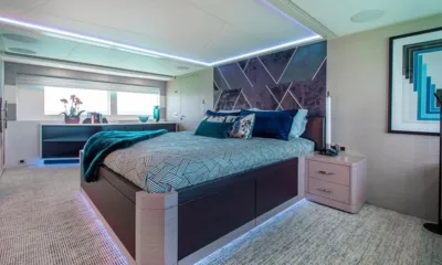 Curfew II: Large cabin with patterned double bed, geometric headboard and blue underfloor lighting