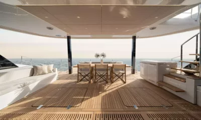 Ankawer VI: Shaded teak aft deck with white sofa, outdoor dining table and open sea view
