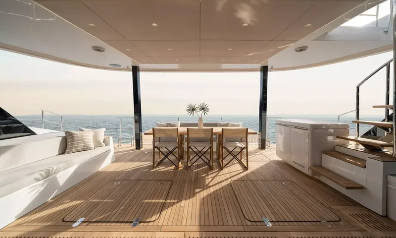 Ankawer VI: Shaded teak aft deck with white sofa, outdoor dining table and open sea view