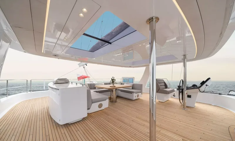 Ankawer VI: Shaded flybridge with lounge seating, table, grill unit, helm station and skylight overhead