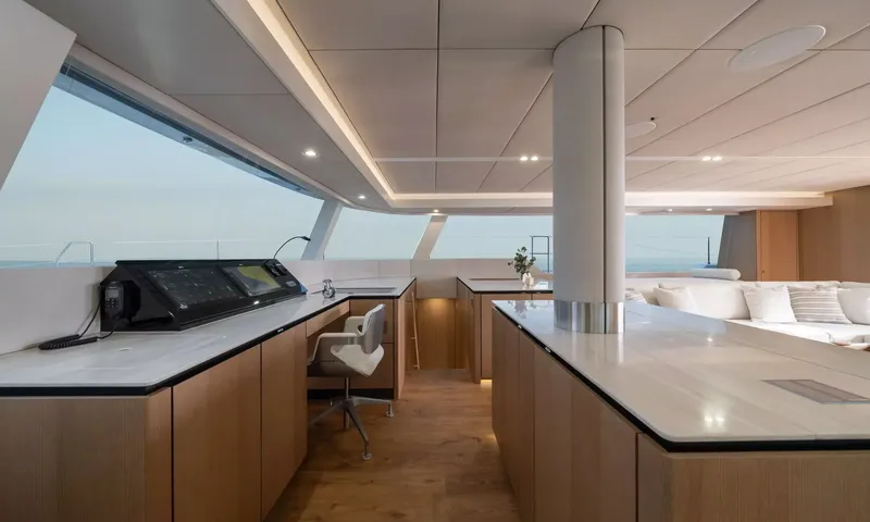 Ankawer VI: Interior navigation station with screens, swivel chair and wood counters by large windows